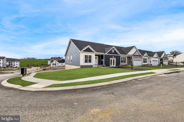 view of front of home featuring a front yard and a garage