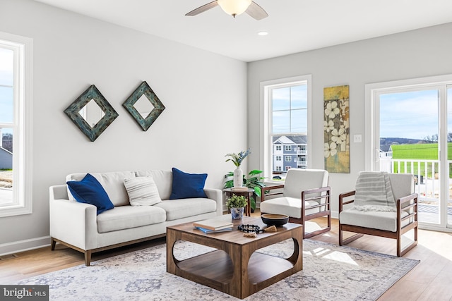 living area with recessed lighting, light wood-style flooring, baseboards, and ceiling fan