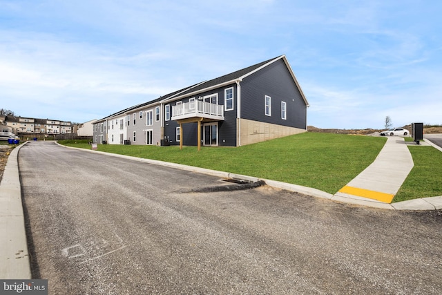 view of property exterior featuring a yard and a residential view