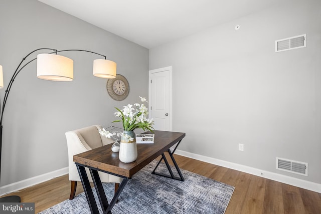 office area featuring wood finished floors, baseboards, and visible vents