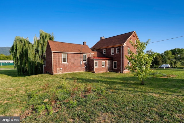 rear view of house with a yard