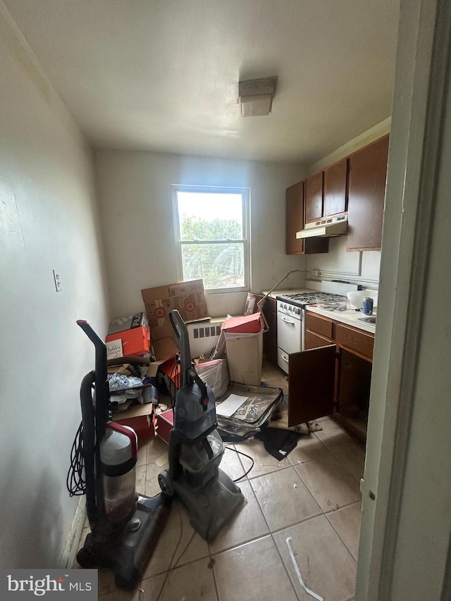 kitchen featuring gas range gas stove and light tile patterned flooring