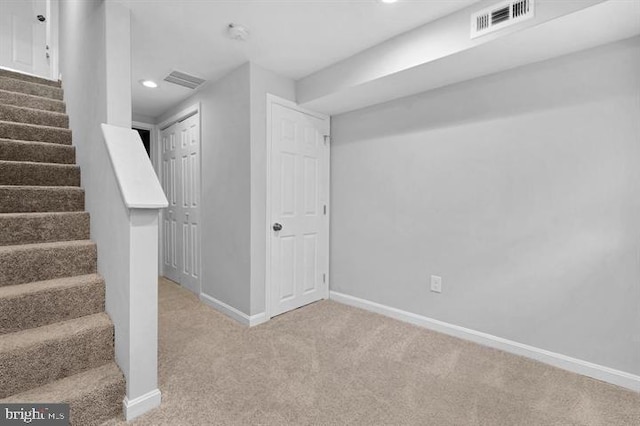 basement featuring light carpet