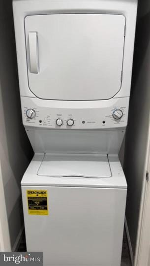 laundry area with stacked washer / drying machine