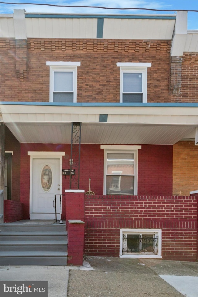 view of front of property featuring a porch and brick siding