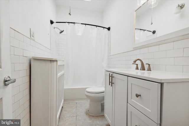 full bath featuring toilet, tile patterned flooring, vanity, and tile walls