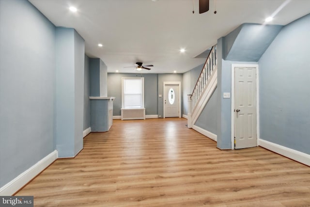 interior space featuring light wood-style flooring, recessed lighting, stairway, and baseboards