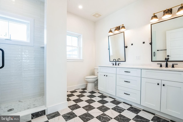 full bath featuring double vanity, visible vents, a sink, tiled shower, and baseboards