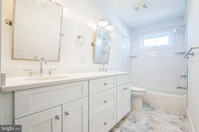 bathroom with visible vents, a sink, toilet, and double vanity