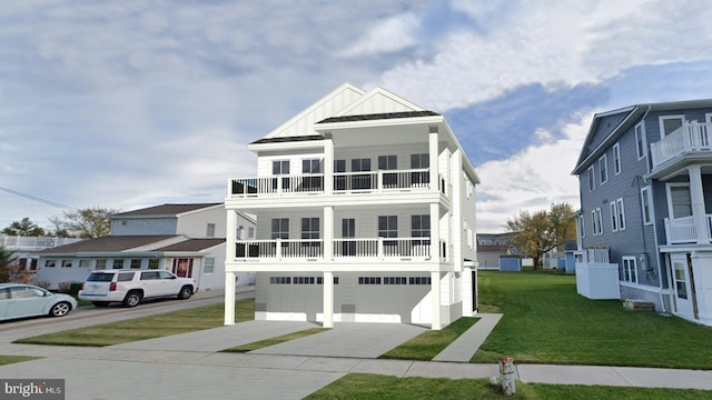 coastal home featuring board and batten siding, driveway, a balcony, and a front lawn