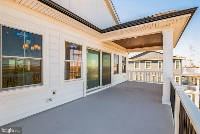 22 Roosevelt Blvd, Ocean City, NJ 08226 - view of front of property with a balcony, a front lawn, an attached garage, driveway, and board and batten siding