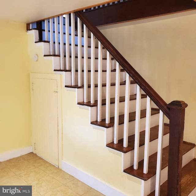 stairway featuring baseboards