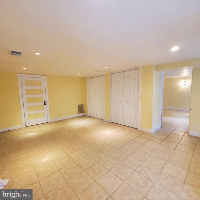 spare room featuring light tile patterned floors, recessed lighting, visible vents, and baseboards