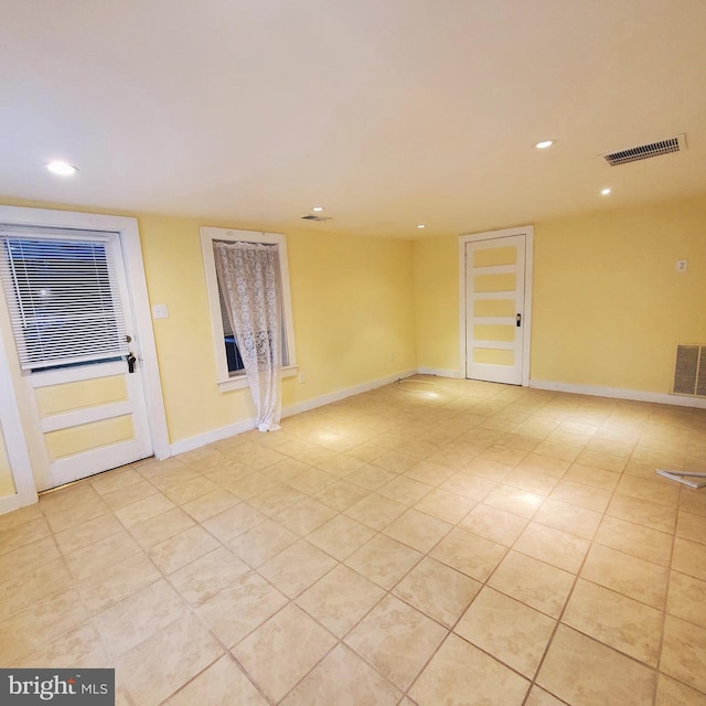 unfurnished room with recessed lighting, visible vents, and baseboards