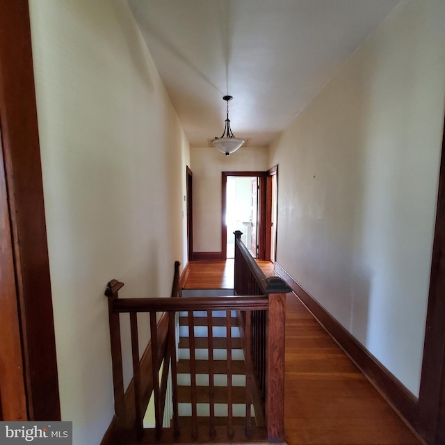 stairs featuring baseboards and wood finished floors