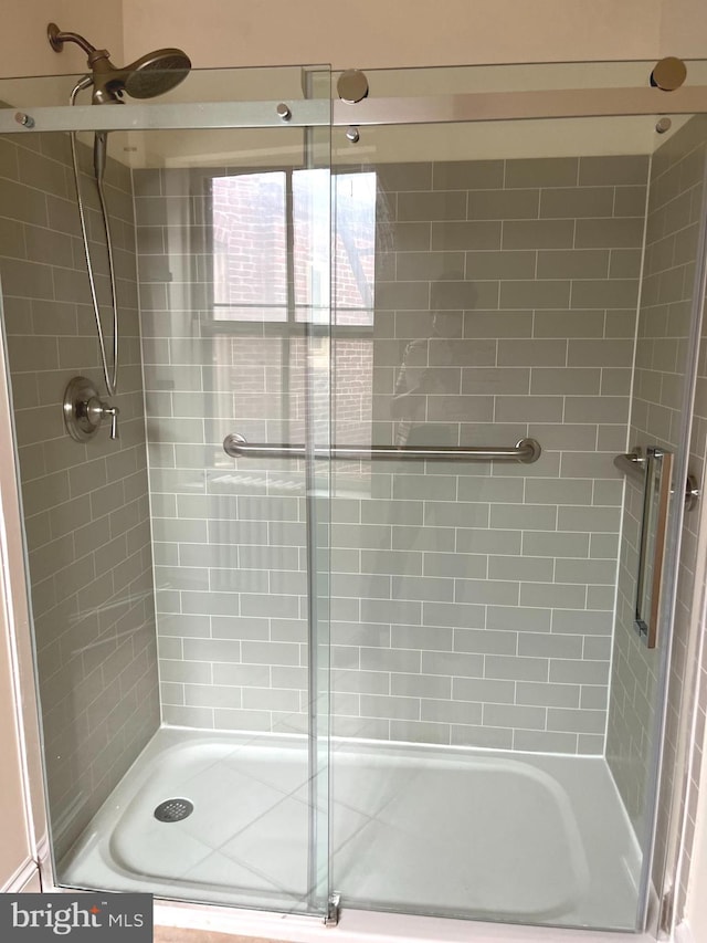 bathroom with tiled shower