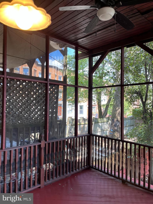 unfurnished sunroom featuring ceiling fan