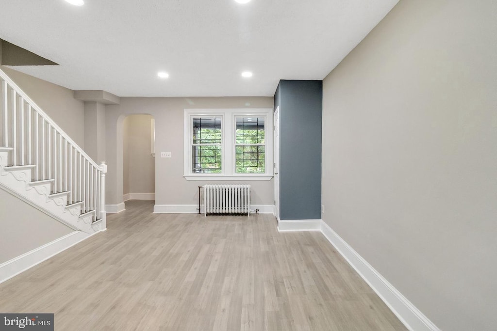 interior space featuring light wood-type flooring and radiator