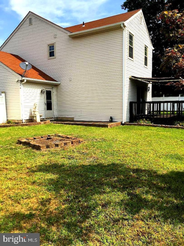 rear view of house with a yard