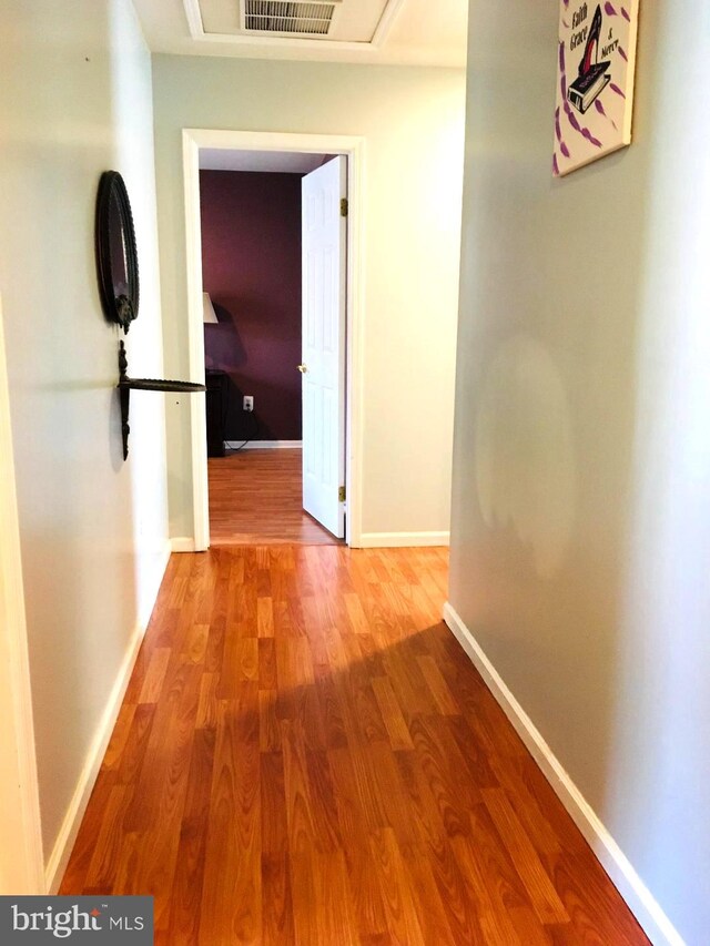 hallway with hardwood / wood-style floors