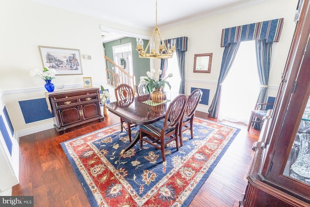 dining space featuring ornamental molding, a notable chandelier, plenty of natural light, and dark hardwood / wood-style flooring