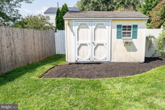 view of outbuilding featuring a lawn