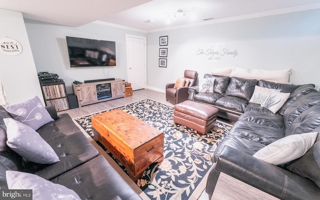 living room with wood-type flooring and crown molding