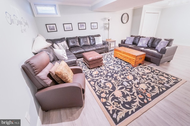 living room featuring wood-type flooring and crown molding