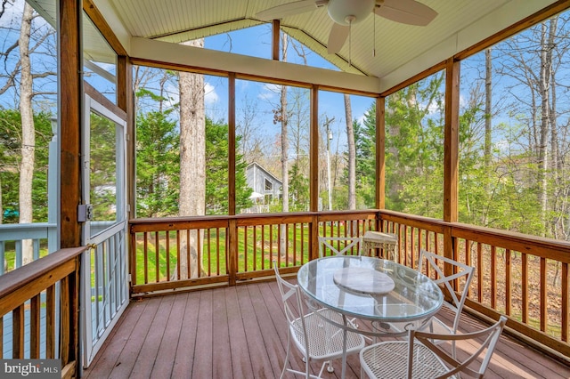 sunroom featuring ceiling fan, a wealth of natural light, and vaulted ceiling