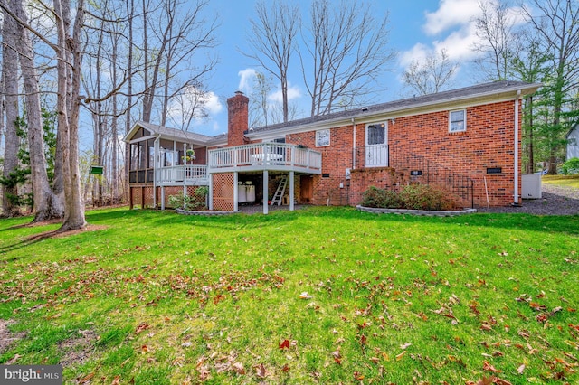 back of house featuring a deck and a yard