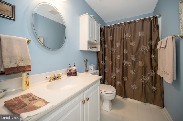 bathroom with vanity, toilet, and curtained shower