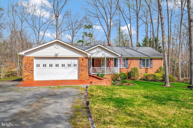 single story home featuring a garage, a front yard, and covered porch