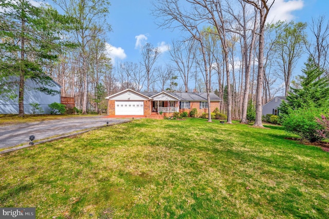 single story home with a garage and a front lawn