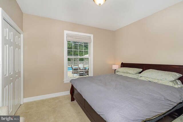 carpeted bedroom featuring a closet