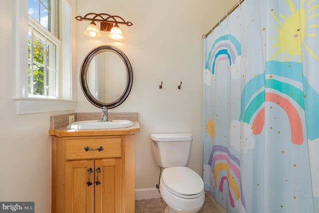 bathroom featuring tile patterned flooring, toilet, a shower with shower curtain, and vanity