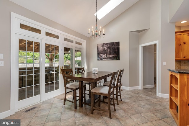 dining room with light tile patterned floors, high vaulted ceiling, and a notable chandelier