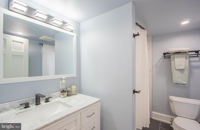 bathroom with tile patterned flooring, toilet, recessed lighting, vanity, and baseboards