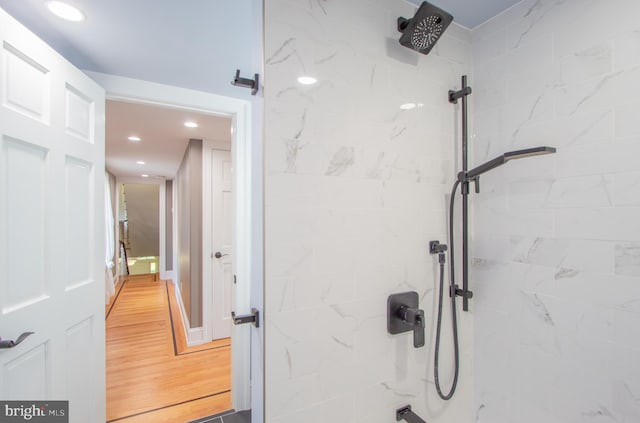 bathroom featuring walk in shower, wood finished floors, and recessed lighting