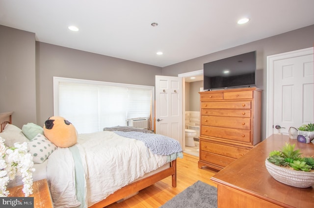 bedroom featuring recessed lighting, ensuite bath, and light wood finished floors