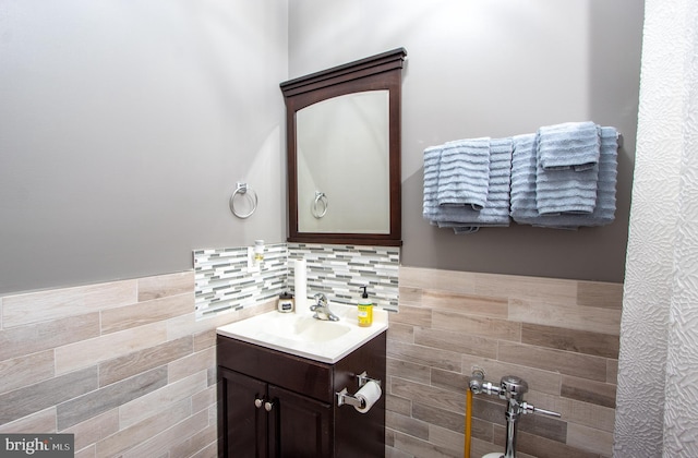 bathroom with wainscoting, tile walls, and vanity