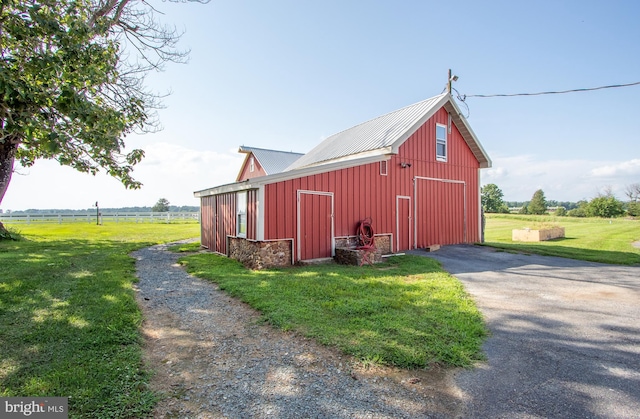 view of pole building with a lawn