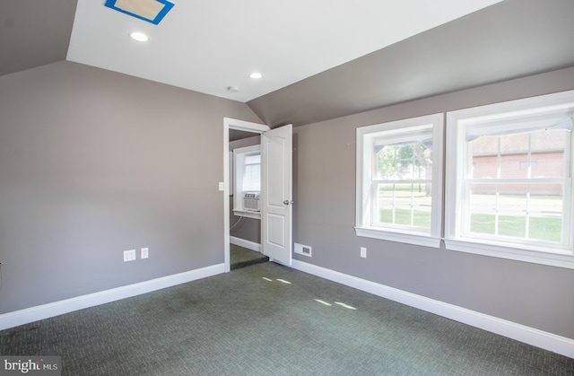 unfurnished bedroom featuring lofted ceiling, dark colored carpet, recessed lighting, cooling unit, and baseboards