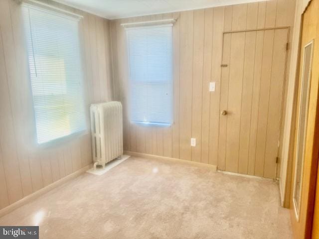 carpeted empty room featuring radiator