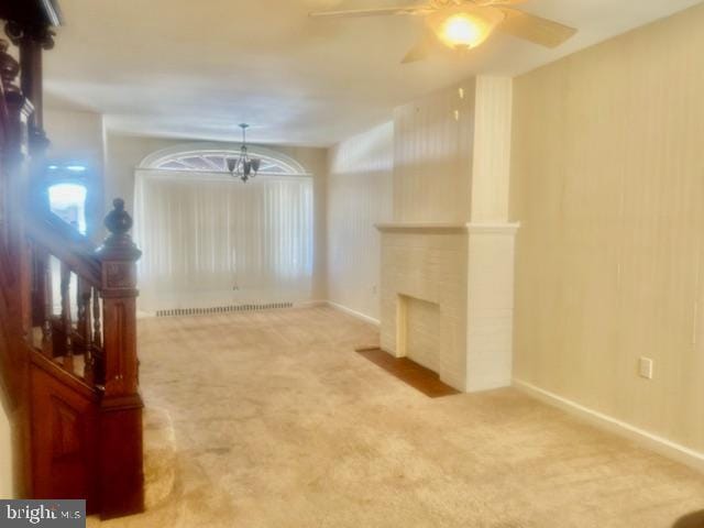 unfurnished living room featuring ceiling fan, carpet, and radiator heating unit