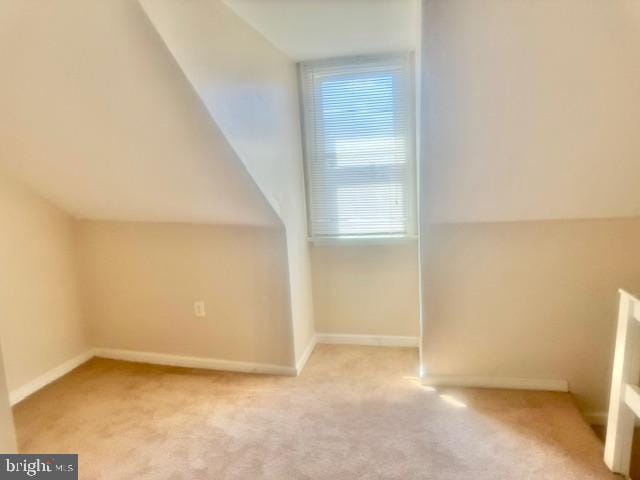 bonus room featuring light carpet and lofted ceiling