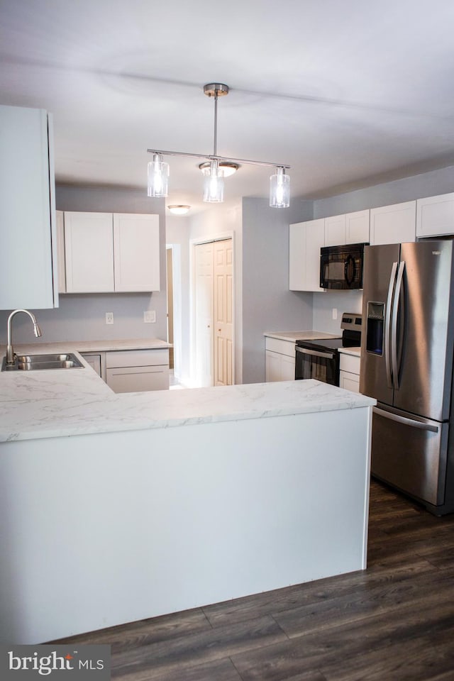 kitchen with white cabinetry, decorative light fixtures, stainless steel appliances, and sink