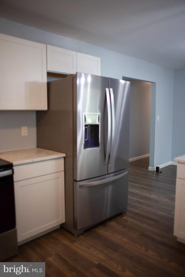 kitchen featuring appliances with stainless steel finishes, white cabinetry, and dark hardwood / wood-style floors