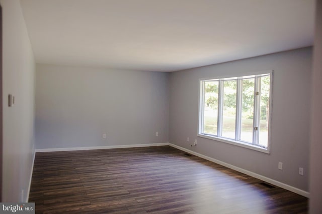 empty room featuring dark wood-type flooring