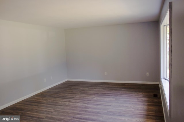 empty room with dark hardwood / wood-style floors