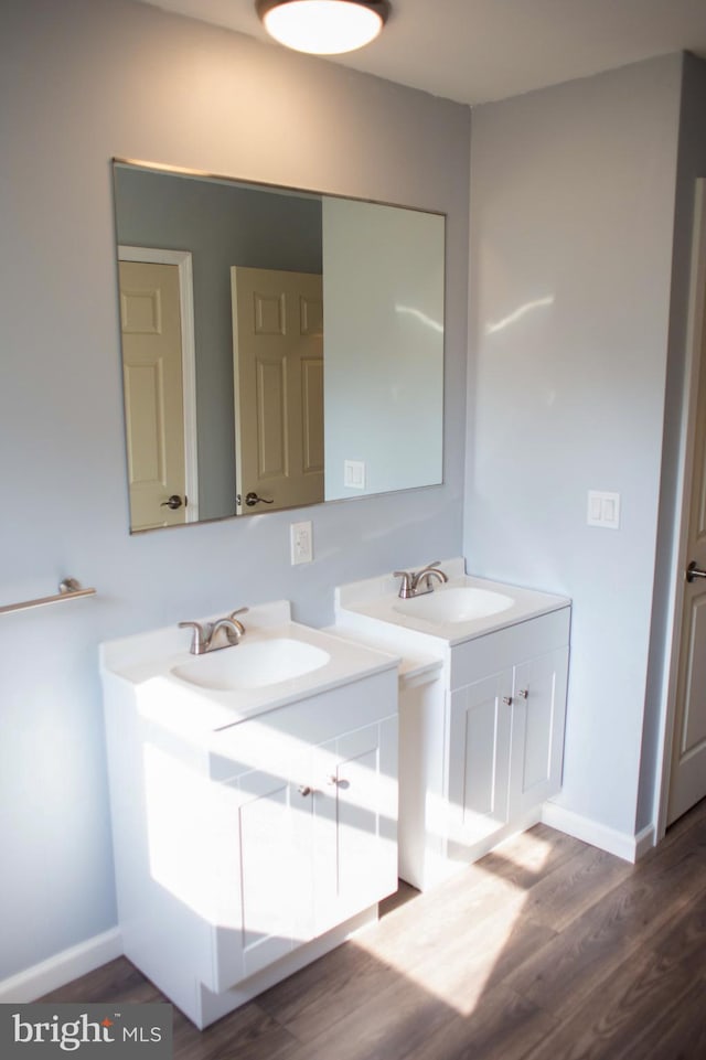 bathroom featuring hardwood / wood-style flooring and vanity